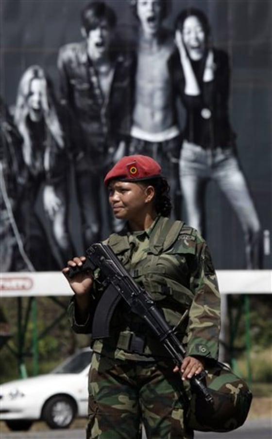 A soldier stands guard outside a military arms depot after a fire in Maracay, Venezuela, on Sunday.